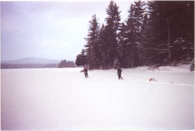 [Snowshoeing across a frozen lake]